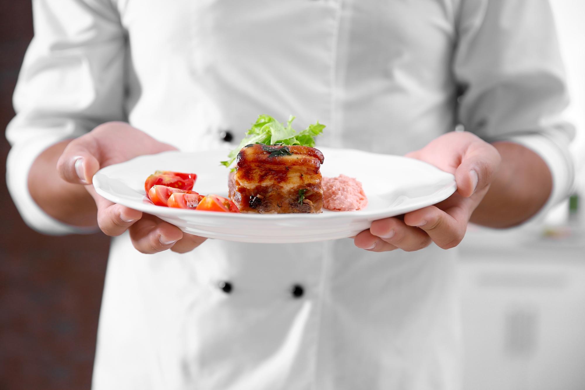 Chef arranging plated seasonal dish